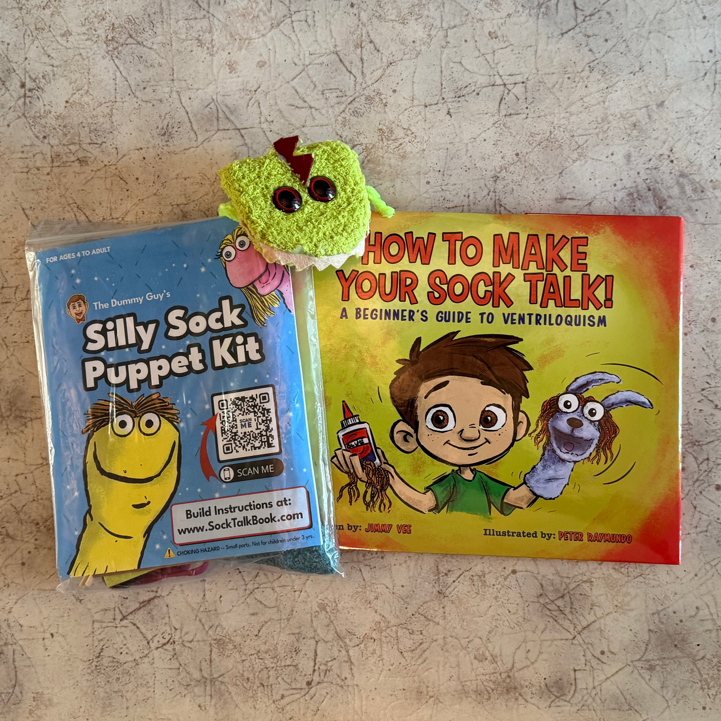 Silly Sock Puppet Kit and signed How To Make Your Sock Talk book with a finished green sock puppet.